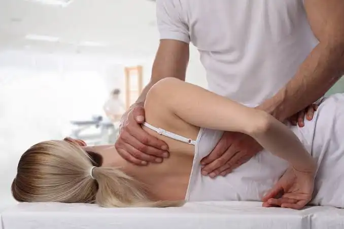 Osteopath examining patient spine